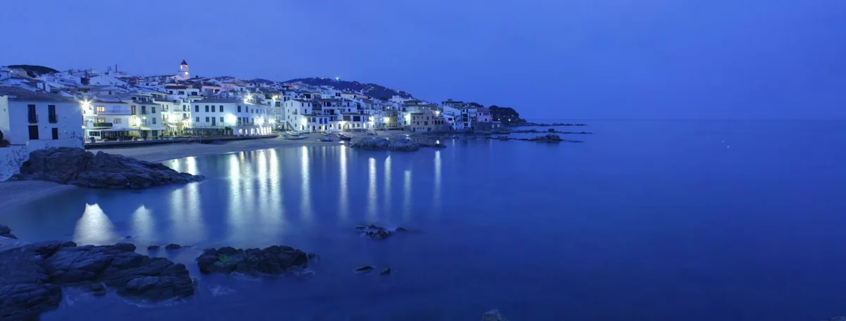 Whitewashed waterfront houses and boats in Calella de Palafrugell, Costa Brava